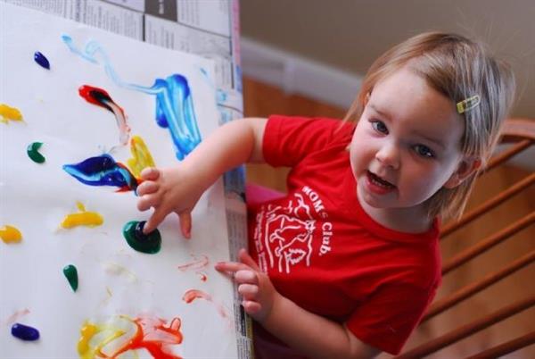 Young girl fingerpainting