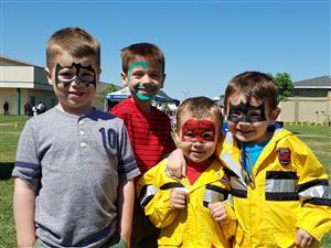 Four boys at an outdoor carnival 