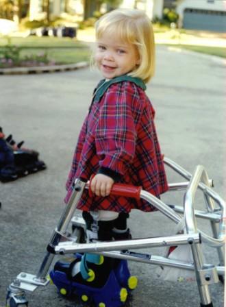 Girl walking assisted by a walker 