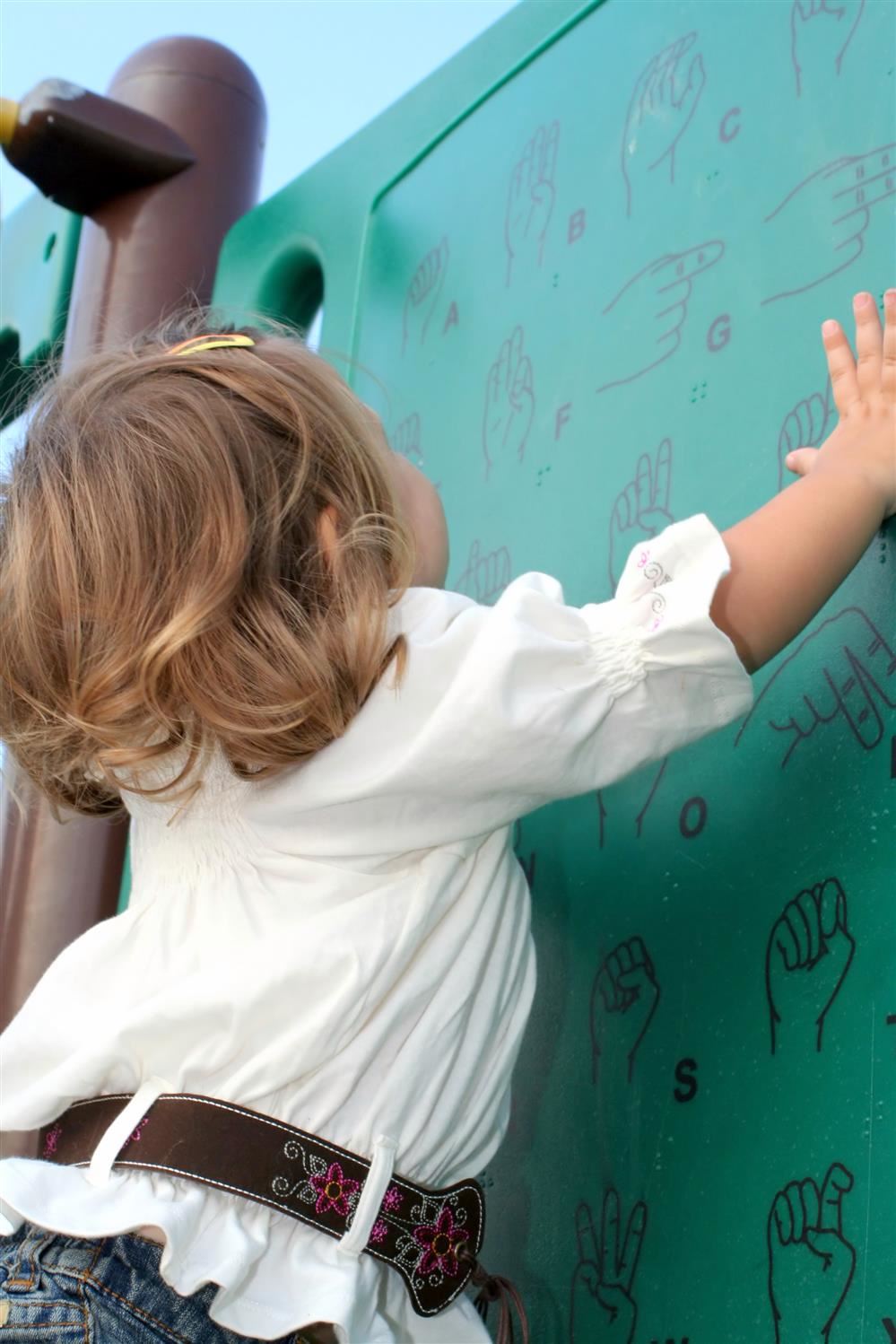 Young girl learning sign language