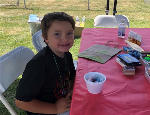 Boy smiling with a snow cone