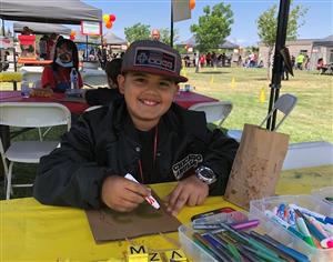 Boy smiling while drawing