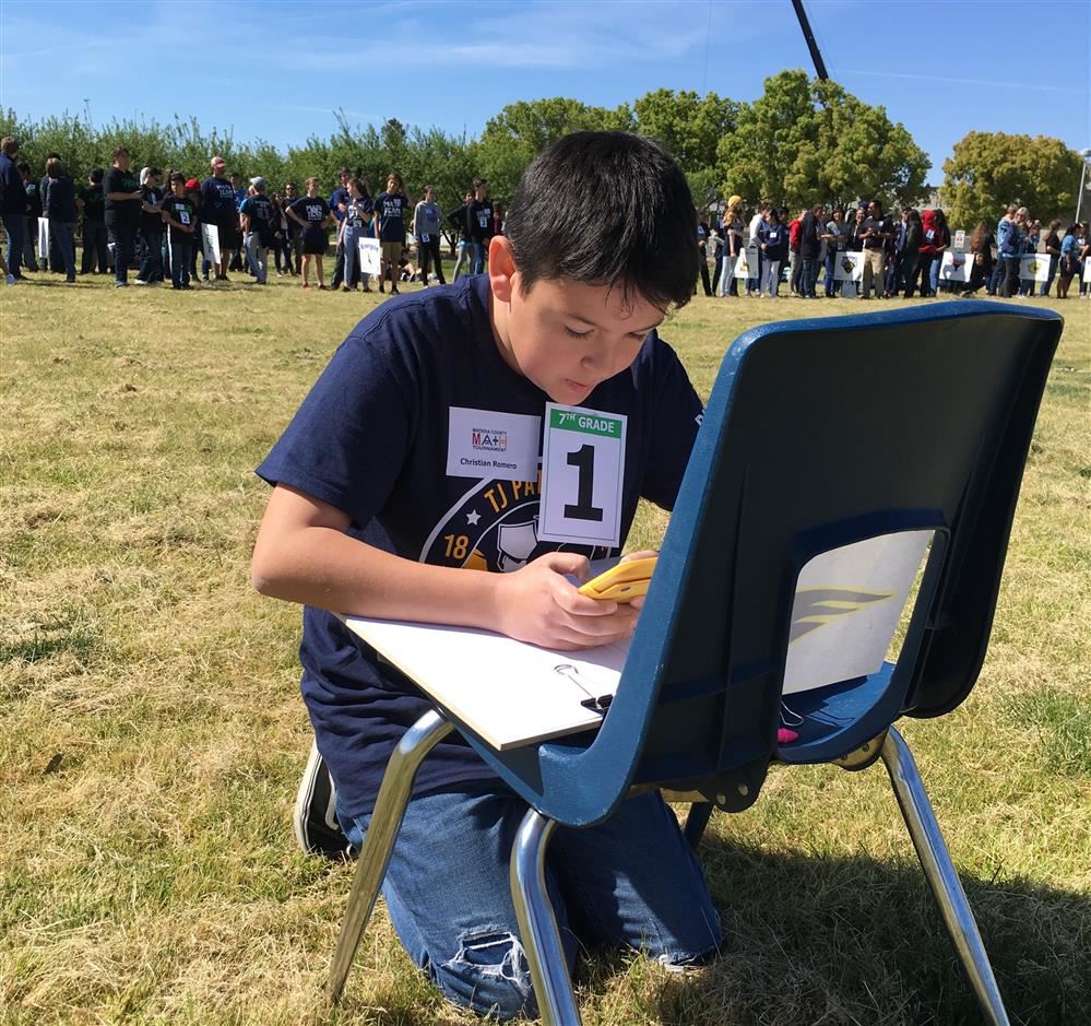 Student answering test questions outside at the relay race